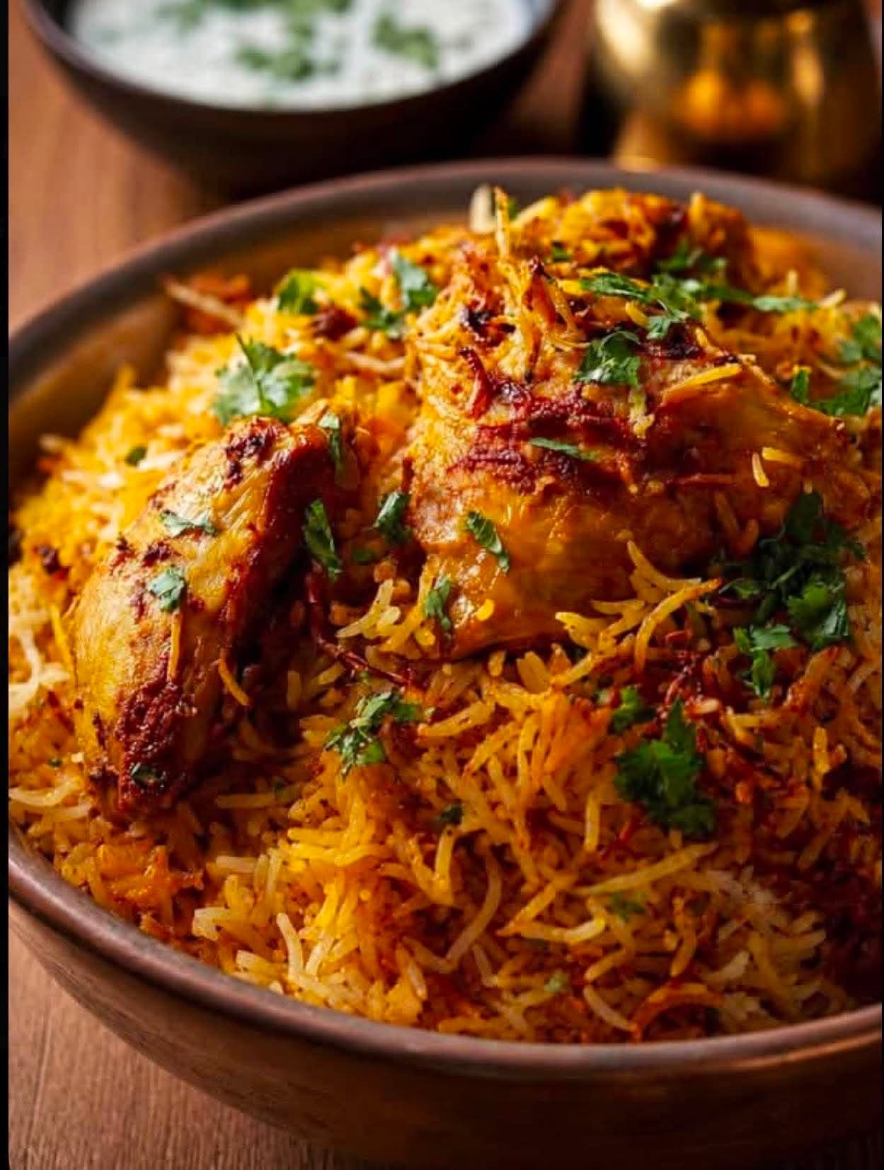 Chicken Dum Biryani — Premium white Indian rice prepared with traditional spices and slow dum-cooked with chicken chunks. Our most popular biryani.