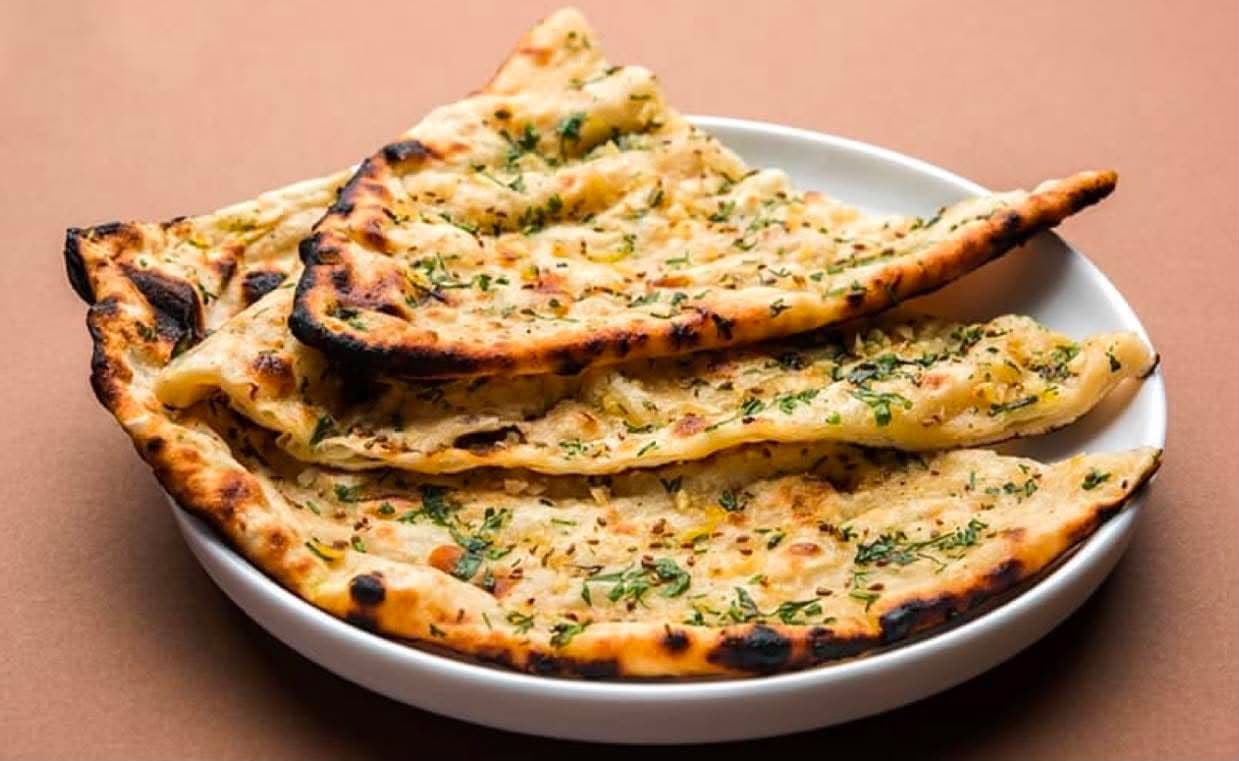 Garlic Naan — Naan bread filled with butter garlic, baked in the clay oven.